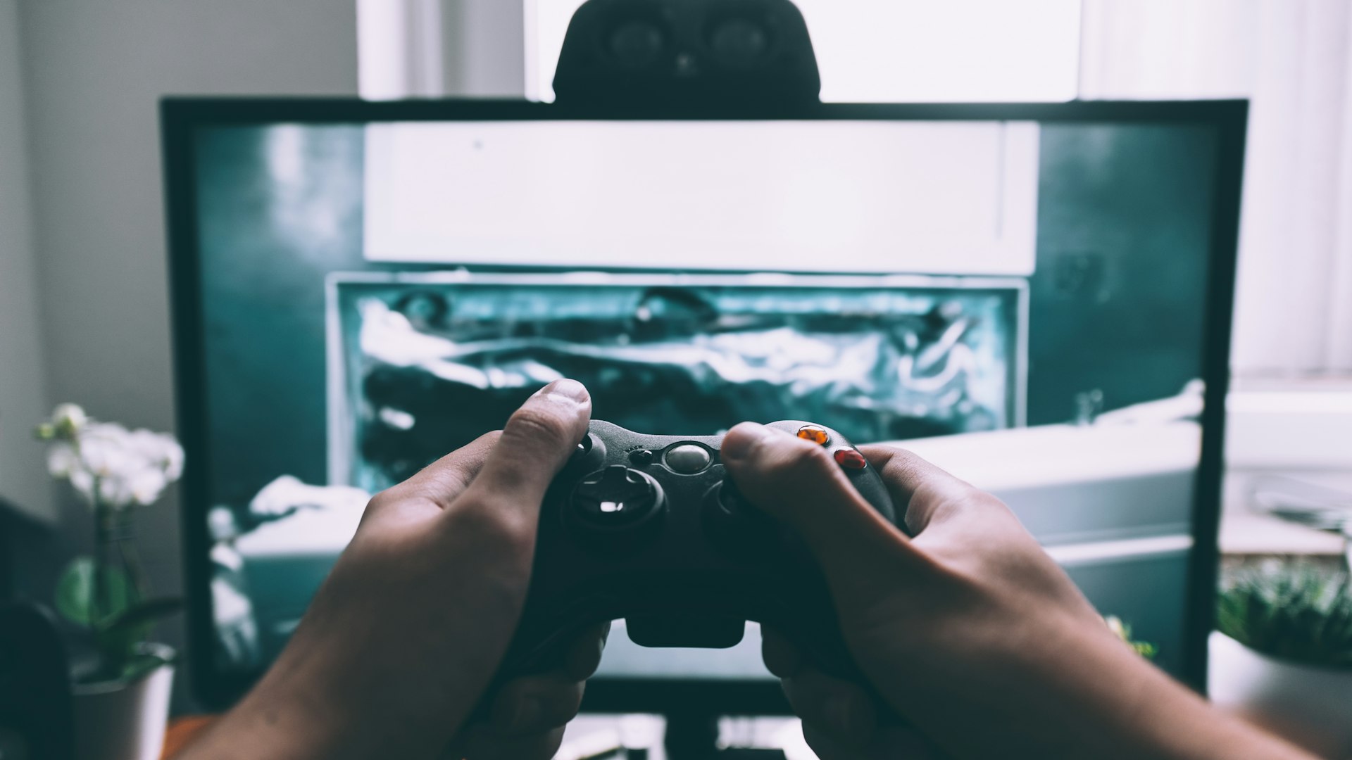 A dimly lit gaming setup glowing with violet light